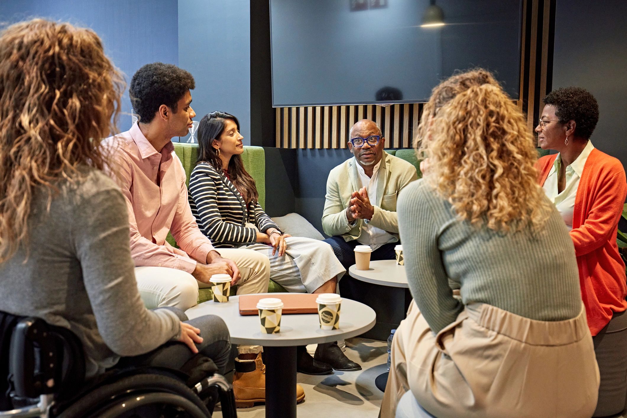 Group discussion in a coffee shop setting.