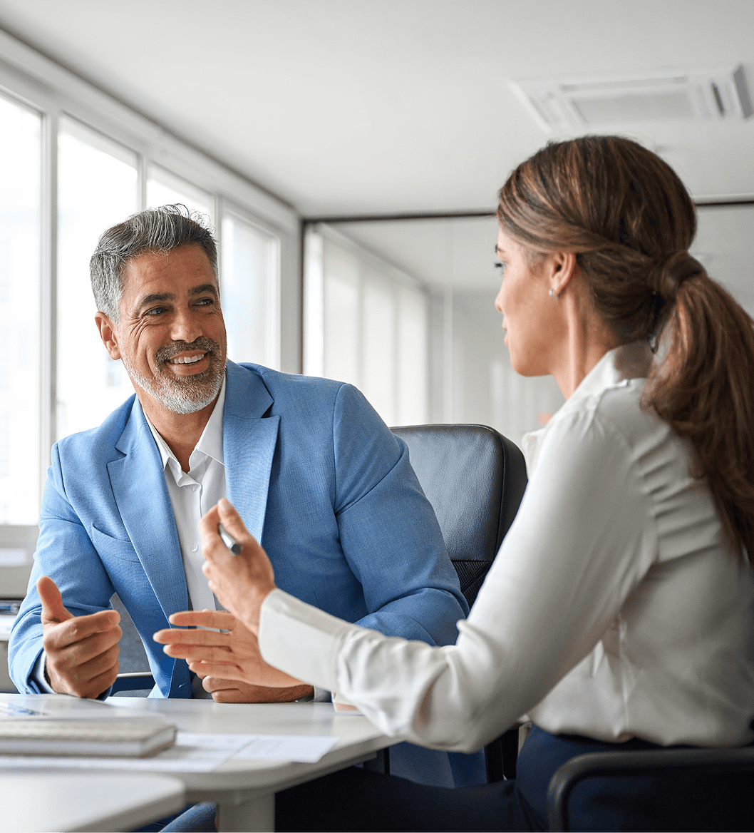 Two professionals discussing business in a bright office.